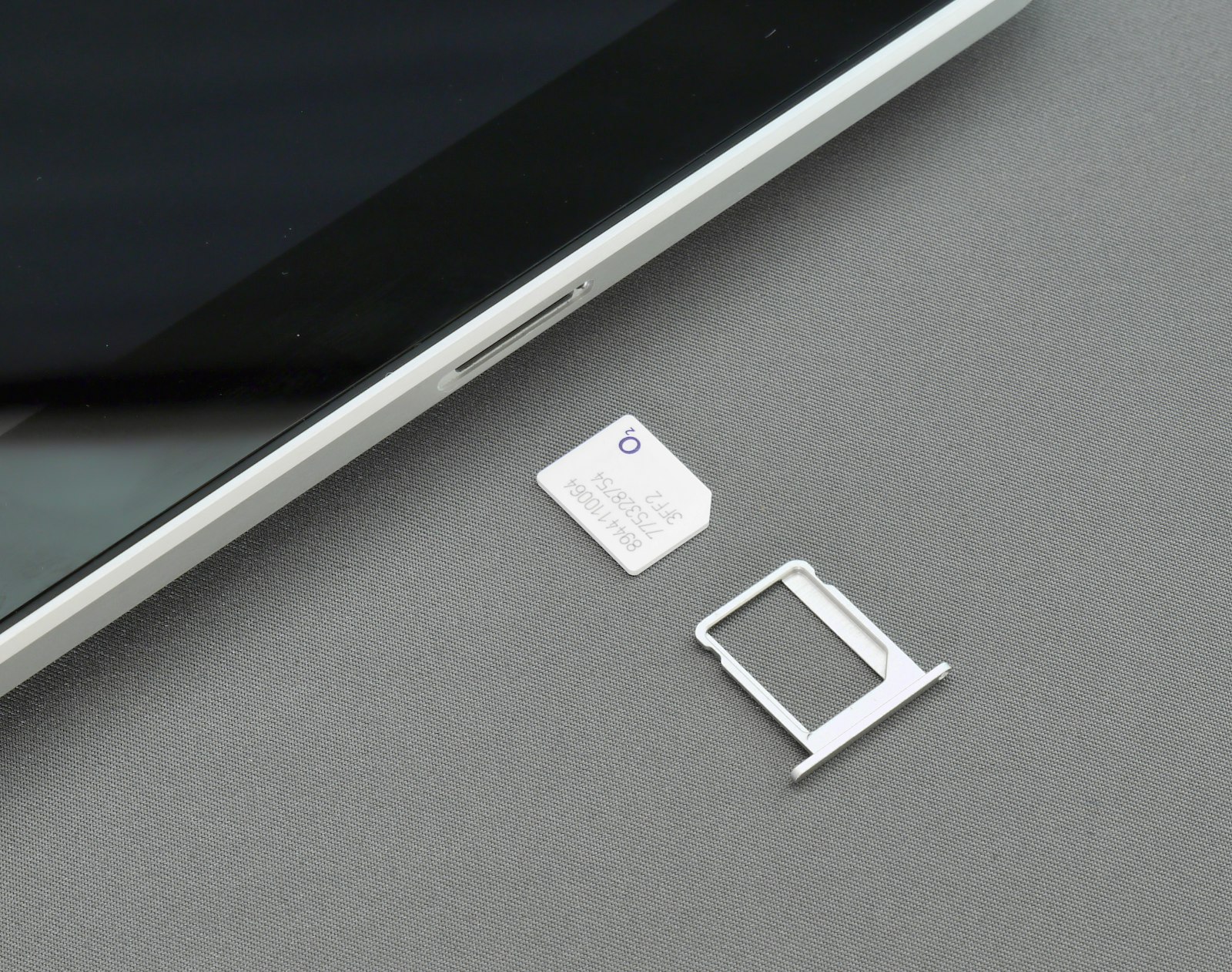 PTA SIM blocking rules – a SIM card and tray next to a smartphone