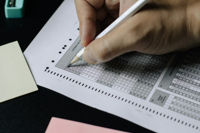BISE Lahore inter result 2026 – a student writing on an exam paper