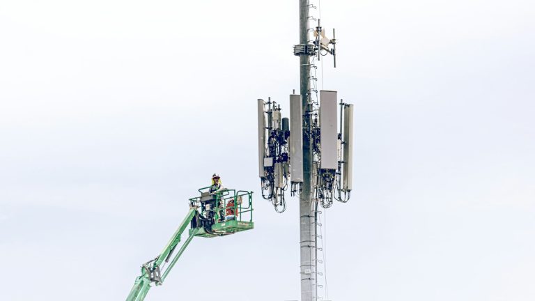 PTA inspection of telecom sites – a technician on a lift working on a mobile tower