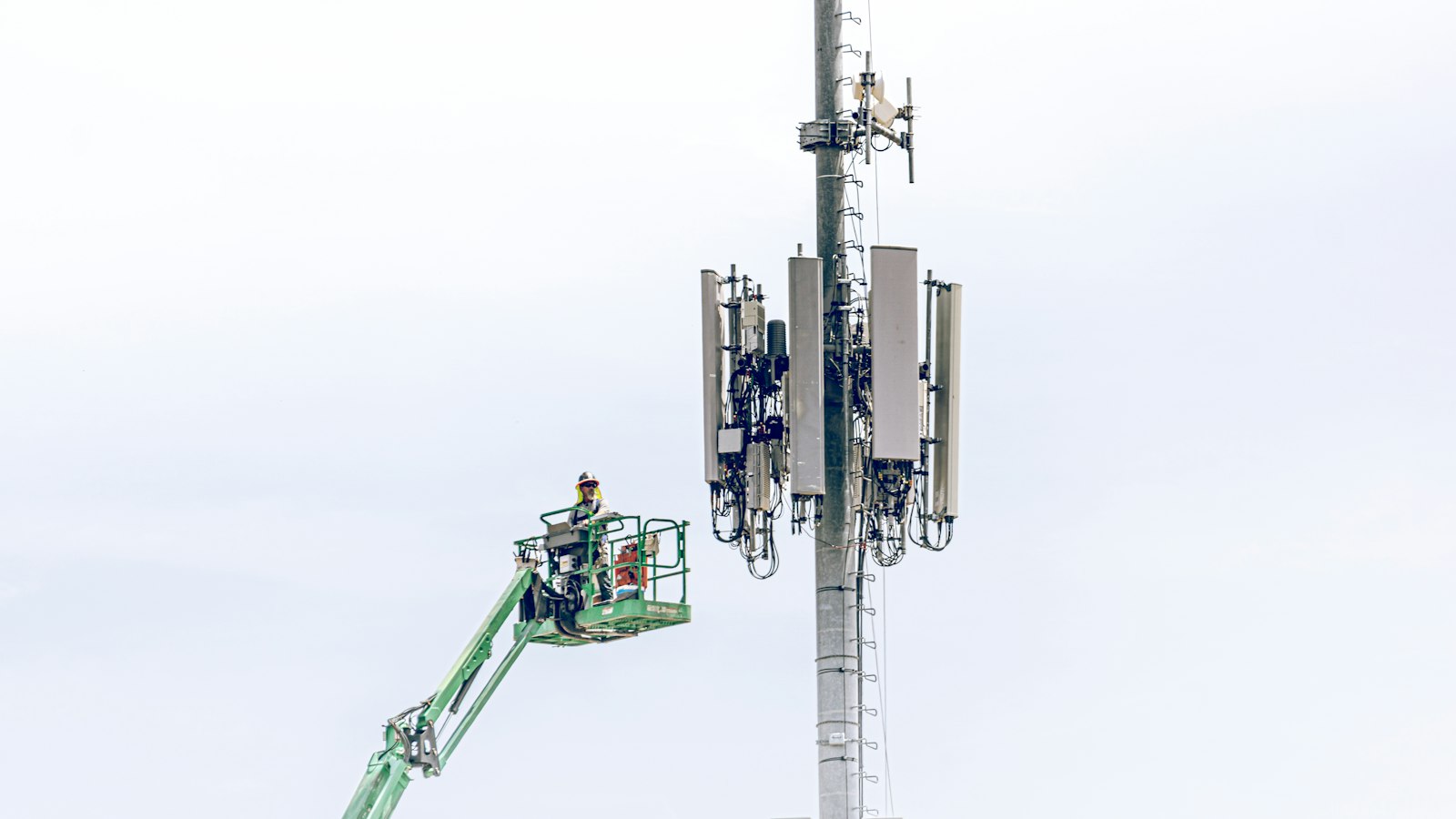 PTA inspection of telecom sites – a technician on a lift working on a mobile tower
